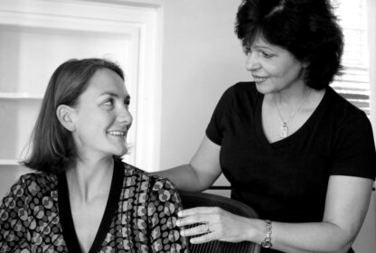 A female massage therapist gives a massage to a woman in the workplace