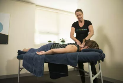 A woman gets a table massage at the office from Seated Massage